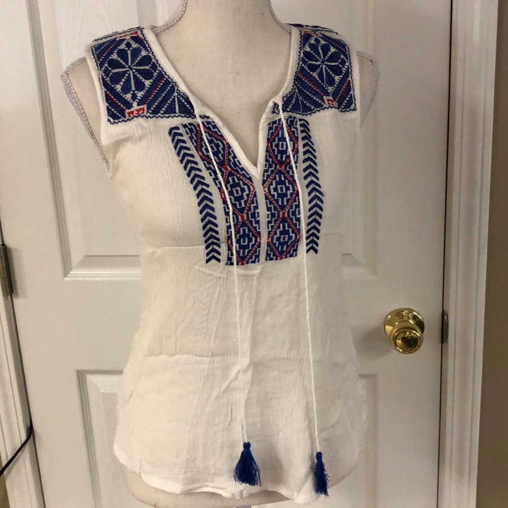 Adorable tank is cream & has adorable blue & red.